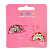 Zwei "Regenbogen" Glitzer-Haarspangen (2er Set) von Rex London auf einer pinken Karte - perfekt als funkelndes Geschenk!.
