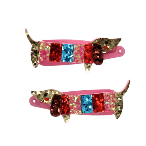 Das "Dackel" Glitzer-Haarspangen 2er Set von Rex London enthält pinke Haarspangen in Dackelform, verziert mit goldenem, rotem, blauem und pinkem Glitzer-perfekt als funkelnde Geschenkidee für Kinder.