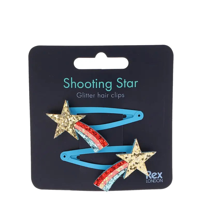 Zwei blaue "Sternschnuppe" Glitzer-Haarspangen (2er Set) von Rex London mit goldenen Sternschnuppen und bunten Glitzer-Trails - ideale Geschenkidee für alle, die Sternschnuppen lieben.